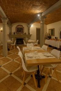 a large room with a table and chairs and a fireplace at Tenuta Monte Bago in Sant Andrea Bagni +31 photos