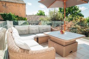 a patio with a table and chairs and an umbrella at Luxury Suite Prada in Paleokastritsa