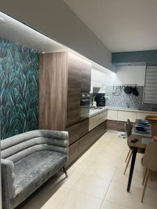 a living room with a couch and a kitchen at B&B Dream House in Campobasso