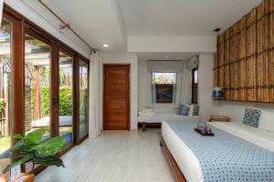 a bedroom with a bed and a living room at Rest Sea Resort Koh Kood in Ko Kood +128 photos