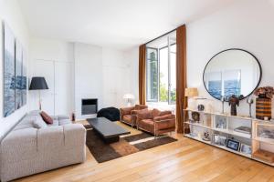 a living room with a couch and a mirror at Les Vignes - Newly refurbished 18th century house with Mediterranean garden in Caluire-et-Cuire +45 photos