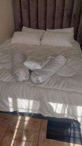 an unmade bed with two pillows on it at A call for all guests in Pretoria +3 photos