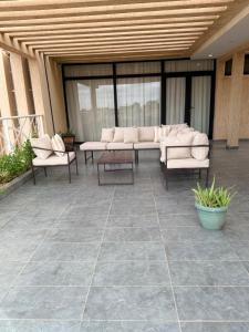 a patio with couches and tables in a building at Kalinou Niamey in Niamey