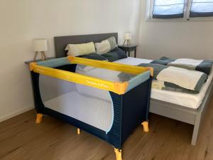 a bed in a room with a bed frame at Ferienwohnungen Rosengarten in Mommenheim