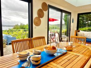 una mesa de madera con un plato de comida. en Ker Su e- maison familial, en Carantec