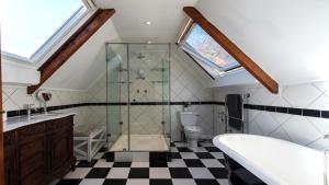 a bathroom with a glass shower and a toilet at Franschhoek Homestead Manor House in Franschhoek