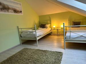 a room with two bunk beds and a rug at Ferienhaus Fichtenwalde in Beelitz +29 photos