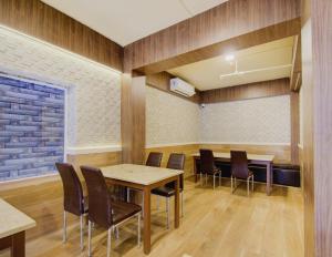 a conference room with a table and chairs at Townhouse OAK Seventy Seven in Dum Dum +49 photos