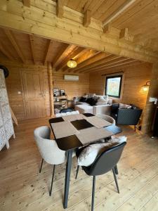 a dining room with a table and chairs at L'Ecrin des Sentiers in La Bruyère