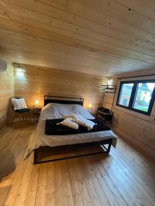 a bedroom with a bed in a wooden cabin at L'Ecrin des Sentiers in La Bruyère +63 photos