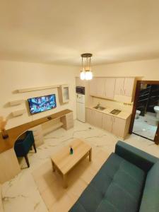 a living room with a blue couch and a table at Ammoun Luxury Apartments 1 in Amman