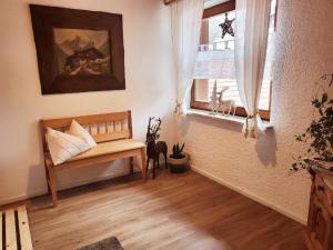 a living room with a bench and a window at Ferienwohnung Goldfasan in Lam +23 photos