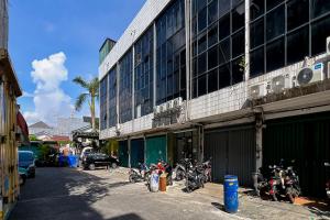 a group of motorcycles parked in front of a building at JJ House Mitra RedDoorz in Jakarta +16 photos