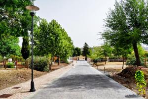 a sidewalk in a park with a street light at GlampINN Fuente Obejuna in Fuente Obejuna