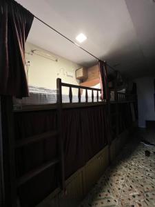 a room with a bunk bed and a ladder to a bed at Red House Hostels - POWAI HOSTELS GROUPS in Mumbai