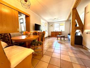 a living room with a table and a dining room at FERIENWOHNUNGEN Krull App 02 in Ahrenshoop