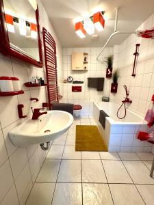 a bathroom with a sink and a tub and a toilet at FERIENWOHNUNGEN Krull App 02 in Ahrenshoop +26 photos