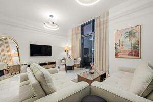 a living room with two couches and a table at Spacious 3BR Eco Stay Masdar City Abu Dhabi Near Airport & Yas Island in Abu Dhabi