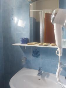 a bathroom with a blow dryer and a mirror at Hotel Holiday Garnì - Pet Friendly in Giulianova +19 photos