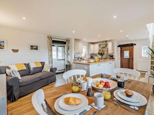 a kitchen and living room with a table with food on it at 2 Bed in Matlock oc-92639 in Highpeak Junction