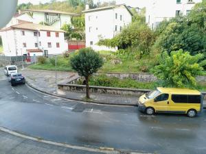 a yellow van parked on the side of a street at Enlace kosta in Mendaro