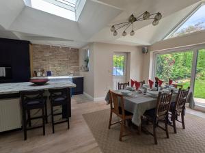 a kitchen and dining room with a table and chairs at Cherry View House 3 Bed Garden Parking sleeps 8 in Bristol