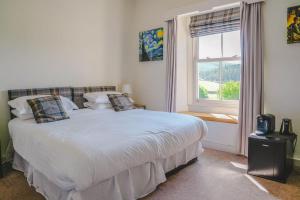 a bedroom with a large white bed with a window at New Inn Appletreewick in Appletreewick