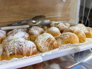 a display case with a bunch of powdered donuts at Chiaia Suites in Naples