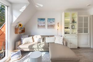 a living room with a couch and a table at Wellenklang in Böhl +20 photos