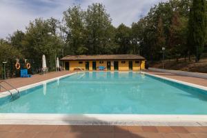 a large swimming pool with a building in the background at KYOMU Resort in Velilla del Río Carrión