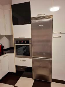 a kitchen with a stainless steel refrigerator and a stove at Apartamento independiente en Nigrán in Nigrán +18 photos