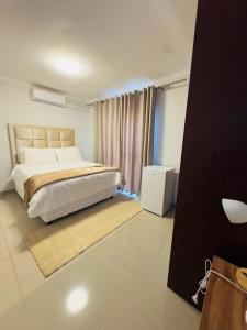 a bedroom with a large bed and a window at ECO-WILD Luxury Suites in Windhoek