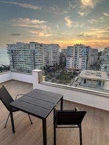 a balcony with a table and a view of a city at Amea Apartments in Durrës
