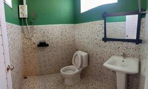 a bathroom with a toilet and a sink at A L Sleep Kohlarn in Ko Larn +15 photos