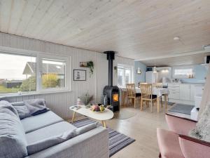 a living room with a couch and a table at Holiday Home Aarto - 250m from the sea by Interhome in Sæby