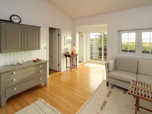 a living room with a couch and a table at Holiday Home Jenson - 75m from the sea by Interhome in Sæby