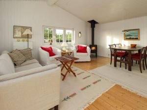 a living room with a couch and a table at Holiday Home Jenson - 75m from the sea by Interhome in Sæby