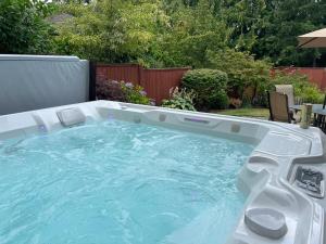 a jacuzzi tub in a backyard at Family Paradise Hot Tub, Fire Pit n Play House in Mount Vernon