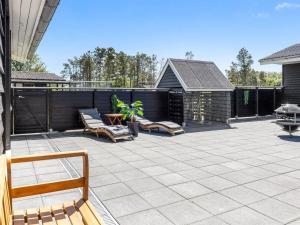 eine Terrasse mit zwei Stühlen und einem Tisch in der Unterkunft Holiday Home Erna - 400m from the sea by Interhome in Sæby
