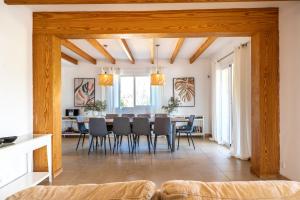 a dining room with a table and chairs at Spacious villa for 10 with private pool in El Port