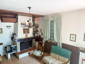 a living room with a fireplace and a chair at La Masseria in Montemiletto