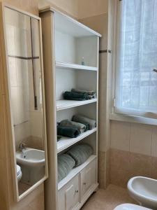 a bathroom with a sink and a toilet and a shower at Appartamento Rosaneve in Brugherio