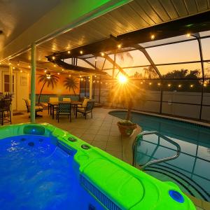 a swimming pool with a hot tub on a patio at Bradenton Vacation Home with Heated Pool, Hot Tub & Game Room Near Anna Maria Island in Bradenton