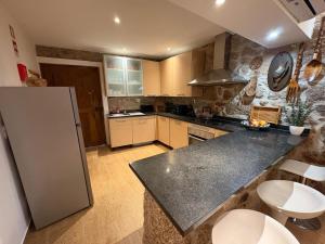 a kitchen with a counter top and a refrigerator at Corte Grande in Zebras