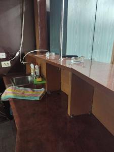 a kitchen with a sink and a wooden desk at Хостел ФИЛИН in Dnipro +18 photos