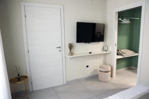 a white door in a room with a tv at Zibakhome in Monte di Procida