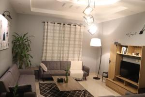a living room with a couch and a table at HOMEY iNN in Al Madinah