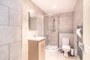 a bathroom with a shower and a toilet and a sink at Cosy & Convenient Central Blackburn 2BED Apartment in Blackburn