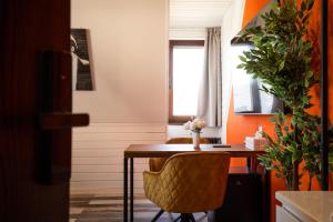 a room with a desk with a chair and a window at NECKARWESTHEIMER Hotel in Neckarwestheim