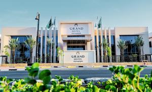 ein Gebäude mit Flaggen vor einer Straße in der Unterkunft First Grand Hotel in Dammam